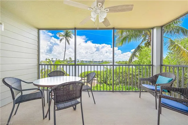 a dining room with furniture a chandelier and glass door