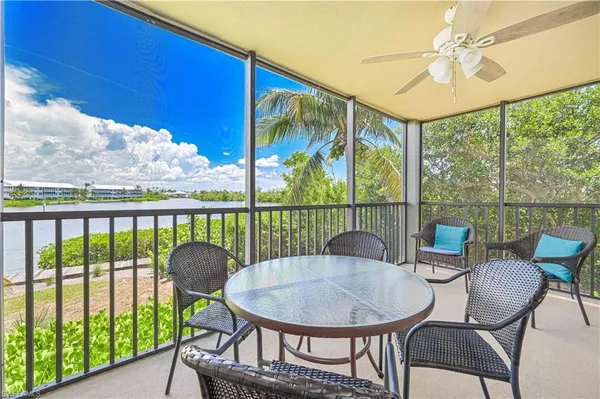 a bathroom with a granite countertop toilet sink and mirror