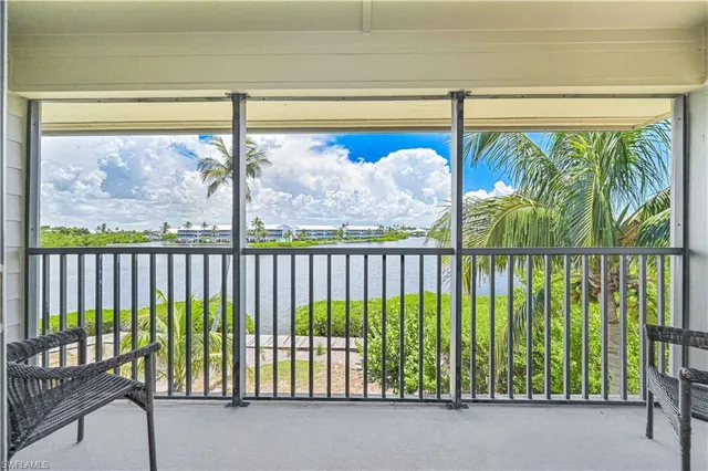a large bed sitting in a bedroom next to a window