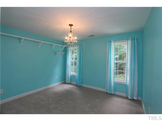 6909 Pinnacle Ridge Road Raleigh, NC 27603 - Photo 21 of 25 Bright & cheerful bedroom with a shelf for trophies. Chandelier does not convey ..will be replaced. Bedroom