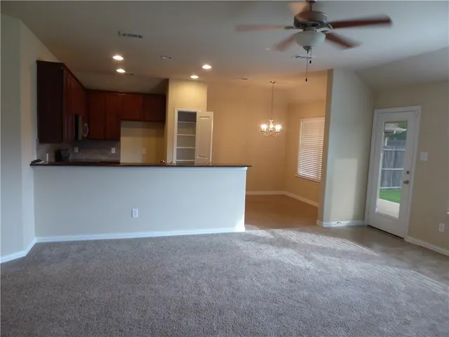 a view of an empty room with a cabinet