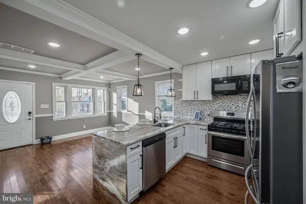 a kitchen with a stove a sink and a refrigerator
