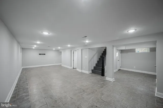 an empty room with walk in closet and wooden floor