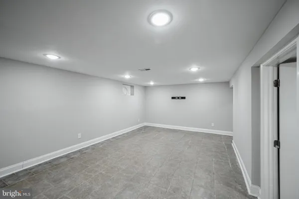 an empty room with a empty space and windows