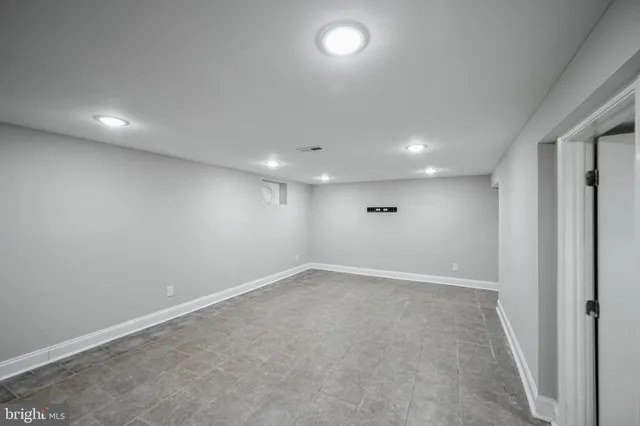 an empty room with a empty space and windows