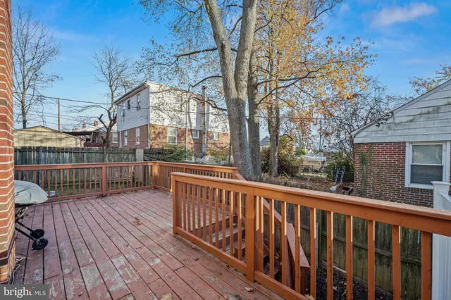 a view of roof deck with wooden floor and fence