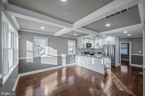 a large kitchen with lots of counter space wooden floor and appliances