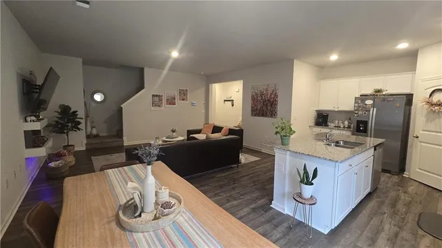 a kitchen with stainless steel appliances kitchen island granite countertop a refrigerator stove microwave and sink