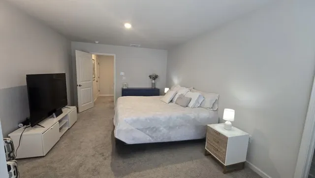 a view of walk in closet with clothes