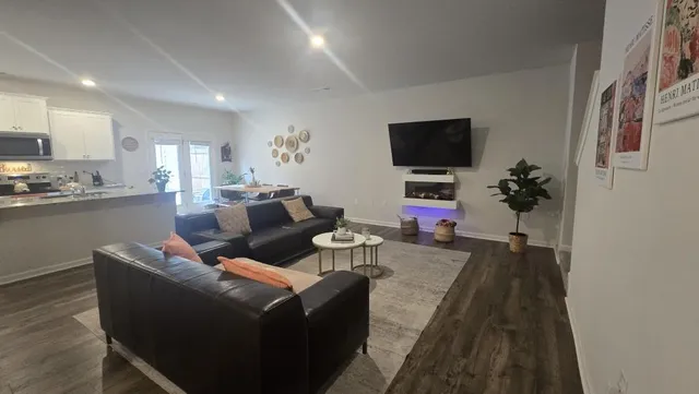 a living room with furniture and wooden floor