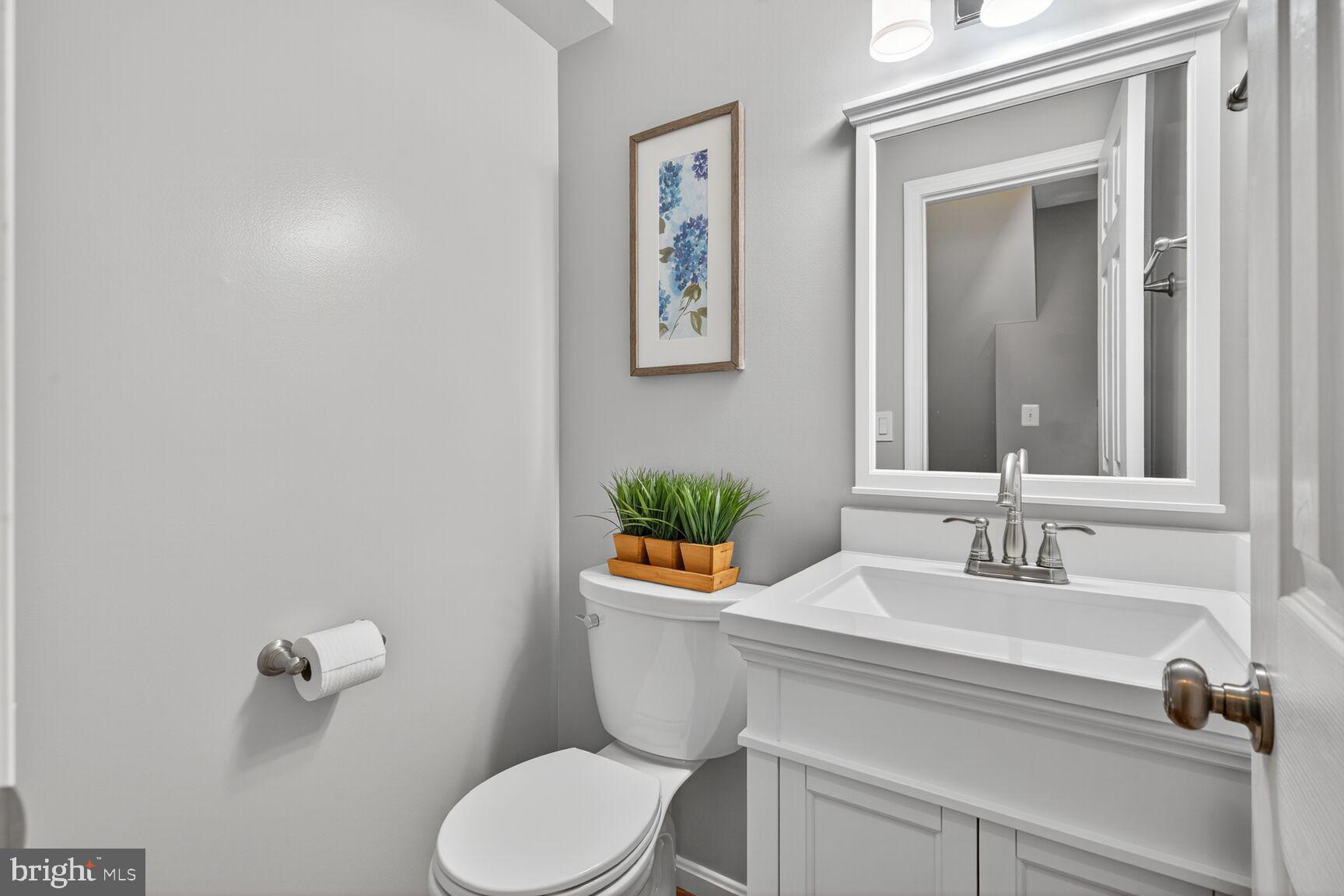 5944 Queenston Street Springfield, VA 22152 - Photo 28 of 60 a bathroom with a sink a toilet and mirror