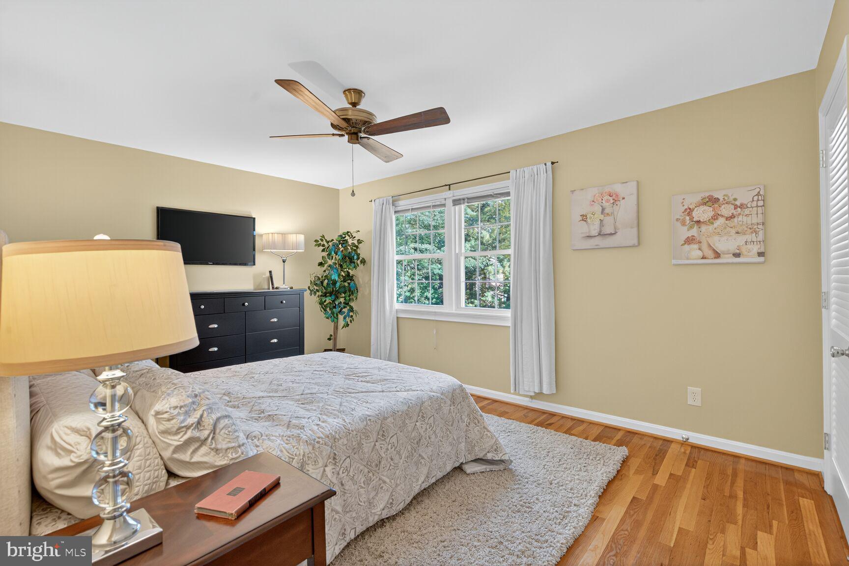 5944 Queenston Street Springfield, VA 22152 - Photo 31 of 60 a bedroom with a bed and wooden floor