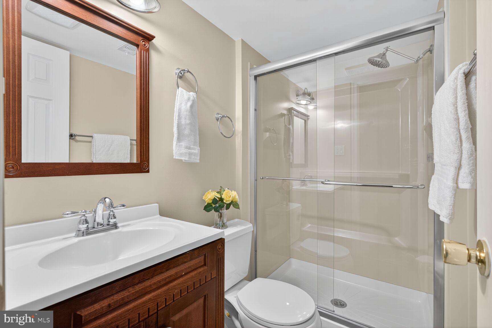 5944 Queenston Street Springfield, VA 22152 - Photo 46 of 60 a bathroom with a sink vanity granite toilet and a mirror