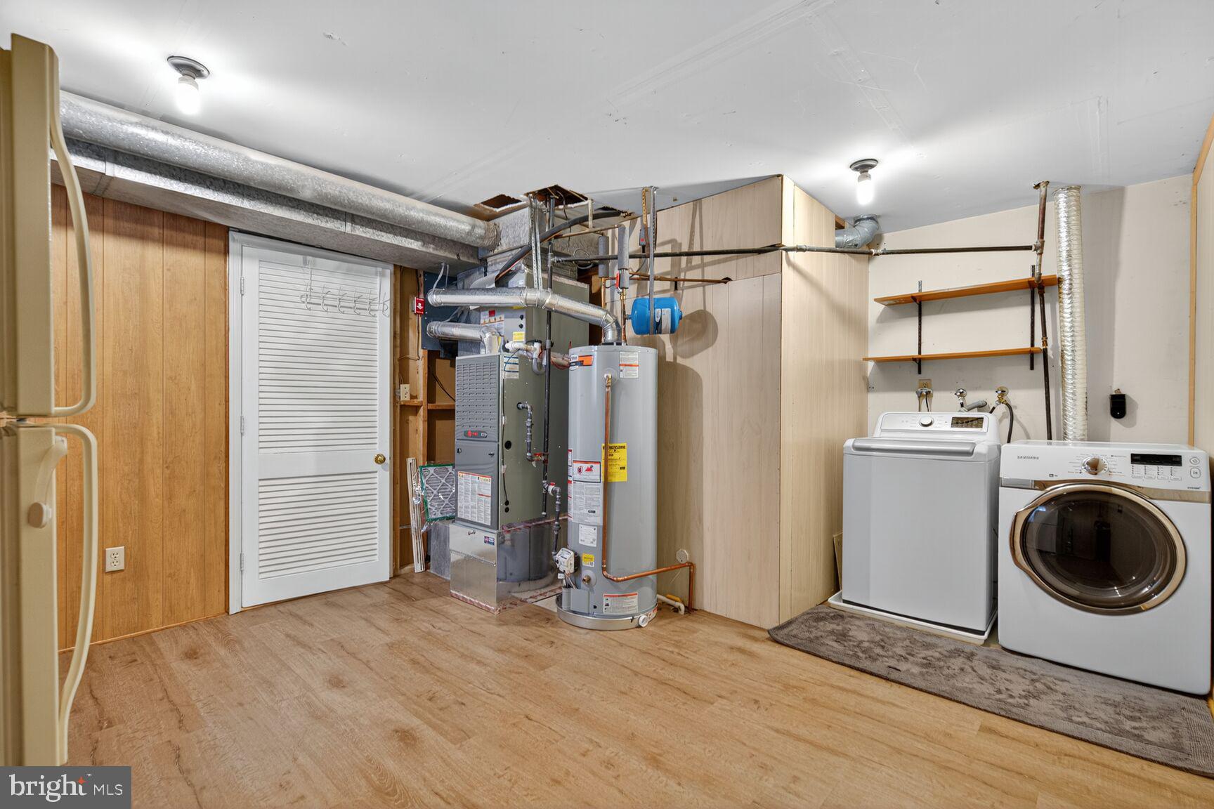 5944 Queenston Street Springfield, VA 22152 - Photo 47 of 60 a view of a storage & utility room with refrigerator and washer