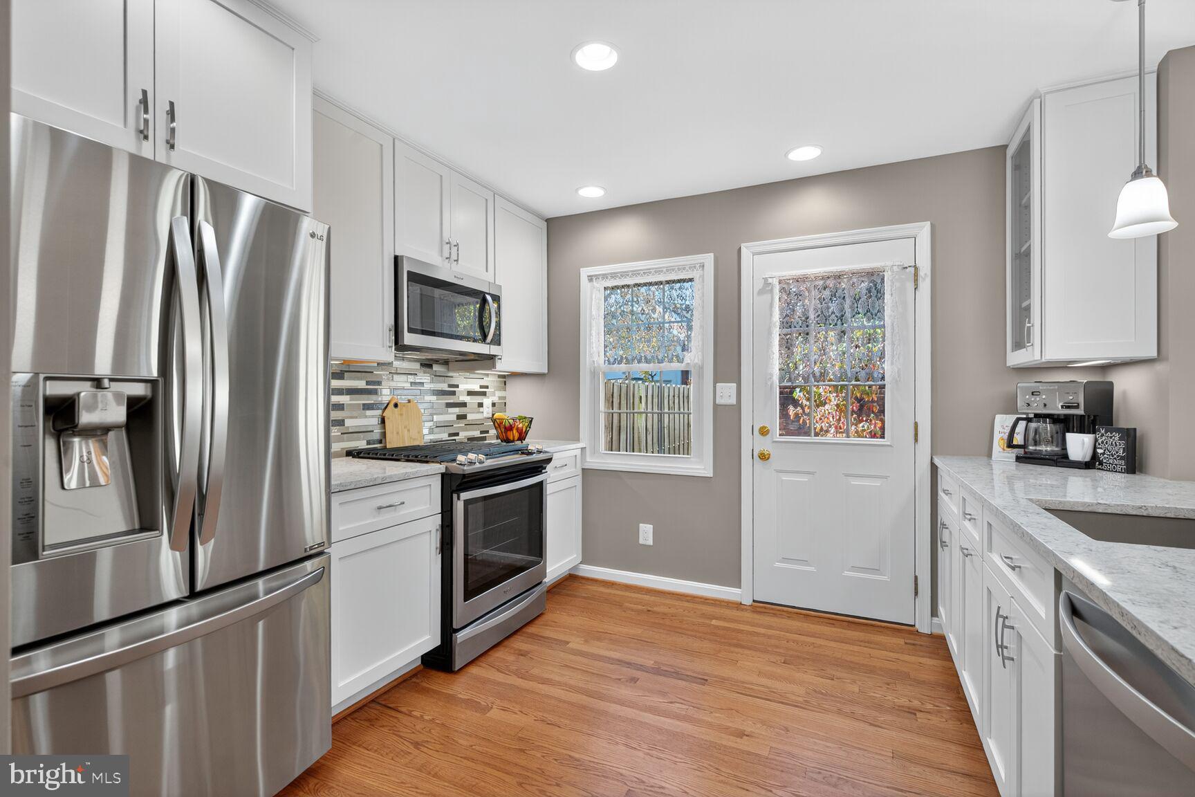 5944 Queenston Street Springfield, VA 22152 - Photo 7 of 60 a kitchen with stainless steel appliances granite countertop a refrigerator stove and sink