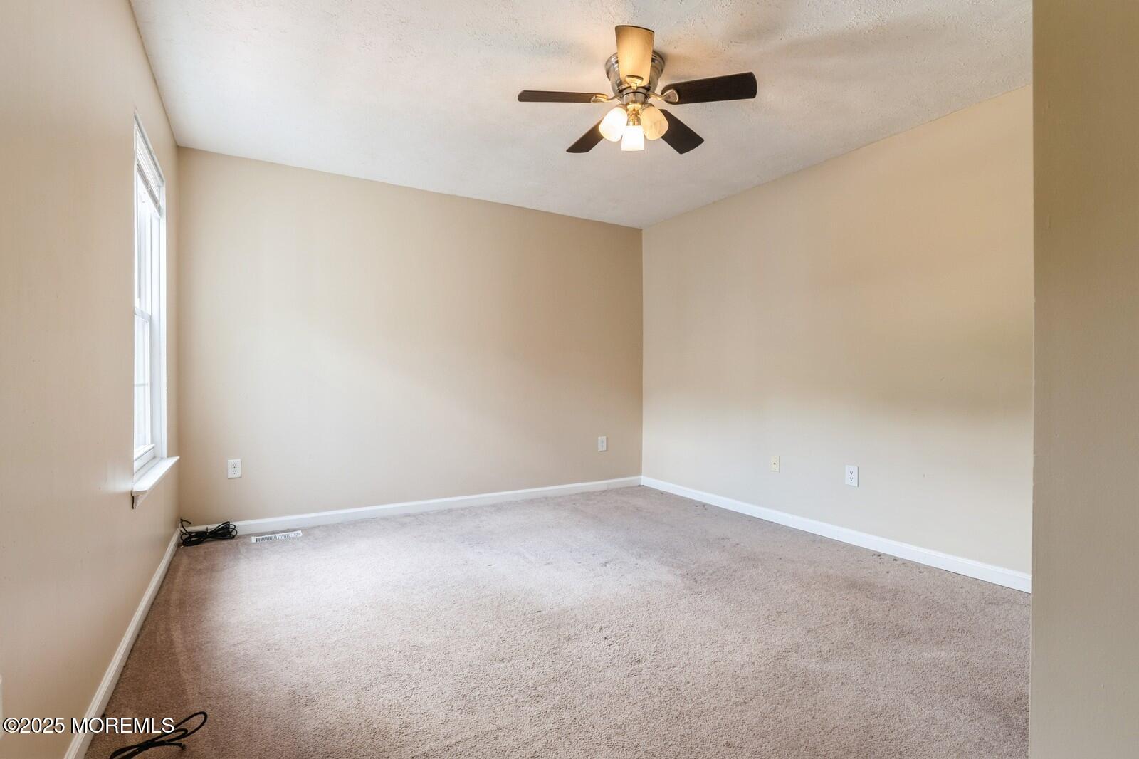 7 Sloop Square Freehold, NJ 07728 - Photo 16 of 30 an empty room with a empty space and a ceiling fan