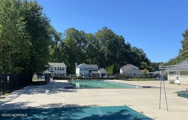 a view of yard along with house and car parked