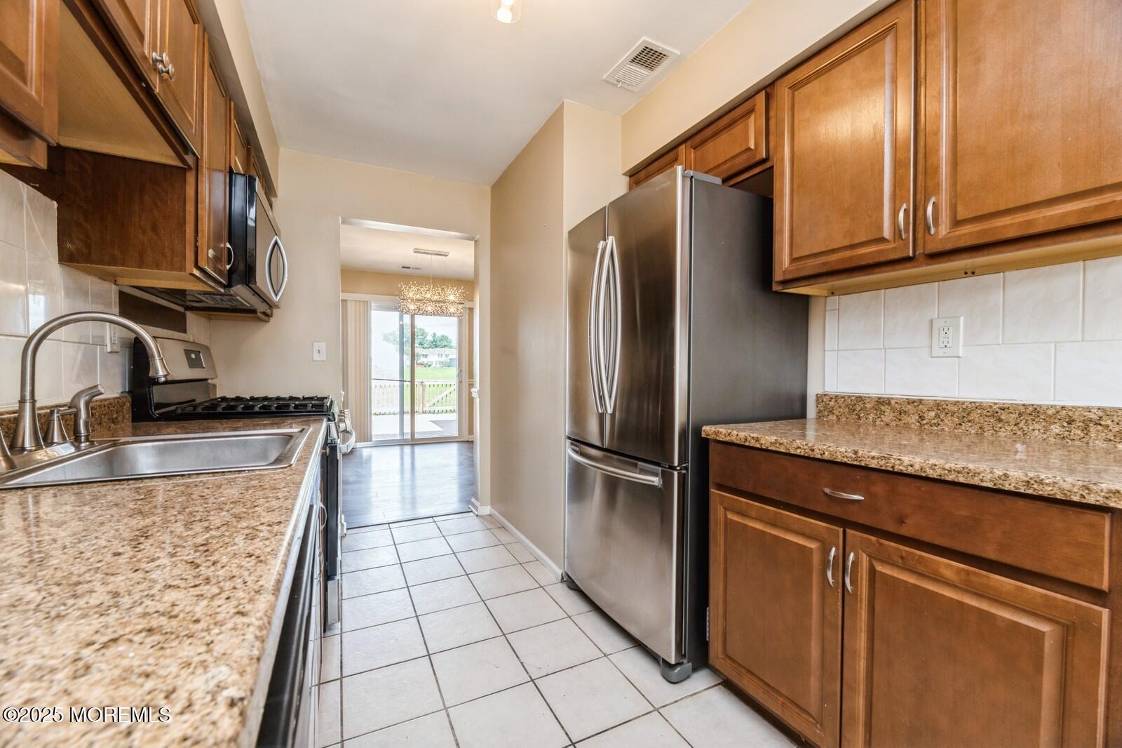 7 Sloop Square Freehold, NJ 07728 - Photo 7 of 30 a kitchen with stainless steel appliances granite countertop a refrigerator a sink and dishwasher