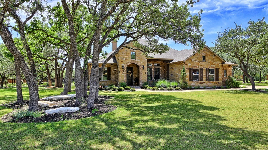 158 Estrella Crossing Georgetown, TX 78628 - Photo 1 of 1 a front view of a house with a garden