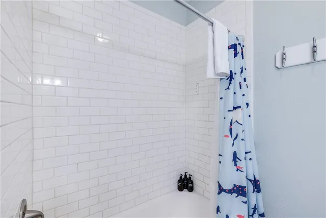 a bathroom with a shower and a sink