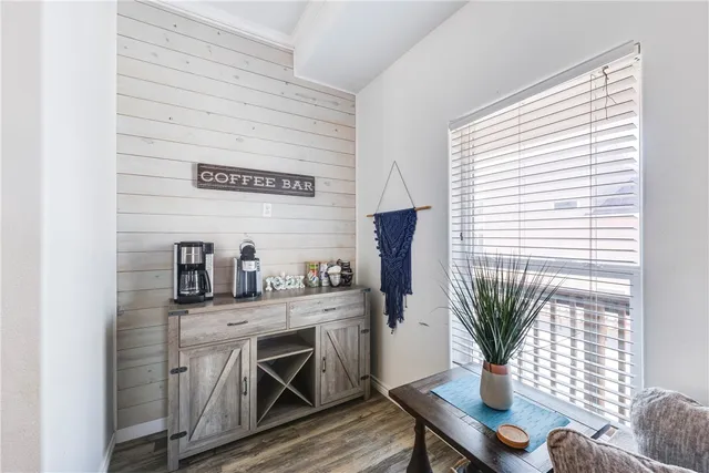 a bedroom with a bed and a flat tv screen on dresser