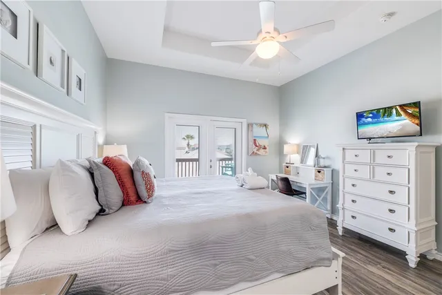 a bedroom with a bed and a painting on the wall