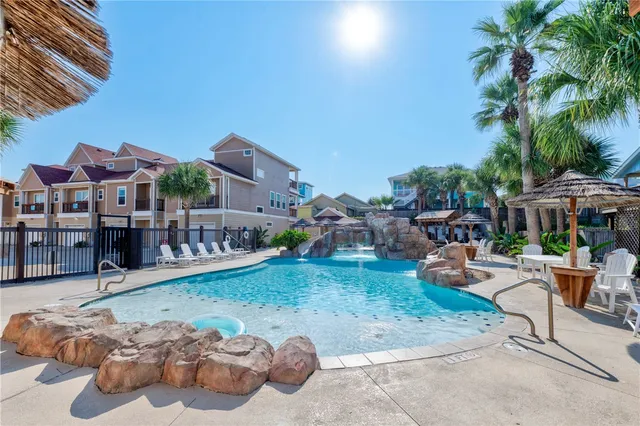 a view of a swimming pool with outdoor seating