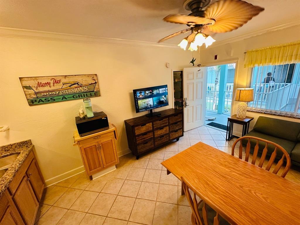 709 Gulf Way, Unit 19 St. Pete Beach, FL 33706 - Photo 11 of 39 a living room with furniture and a flat screen tv