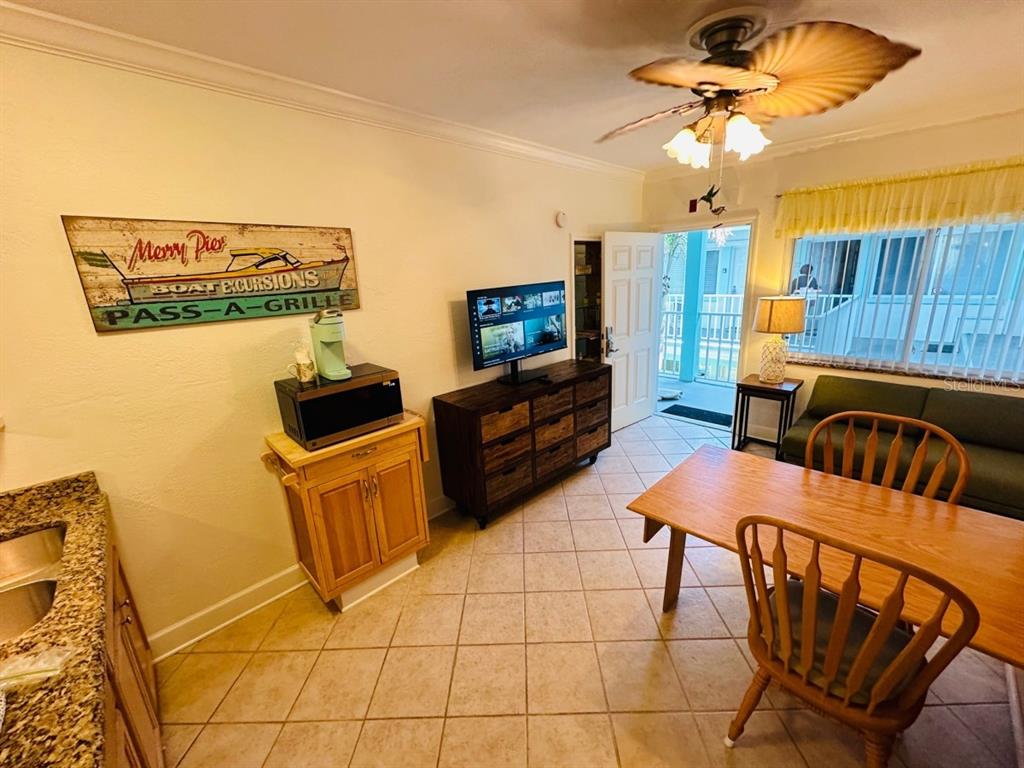 709 Gulf Way, Unit 19 St. Pete Beach, FL 33706 - Photo 14 of 39 a view of a livingroom with furniture and a ceiling fan