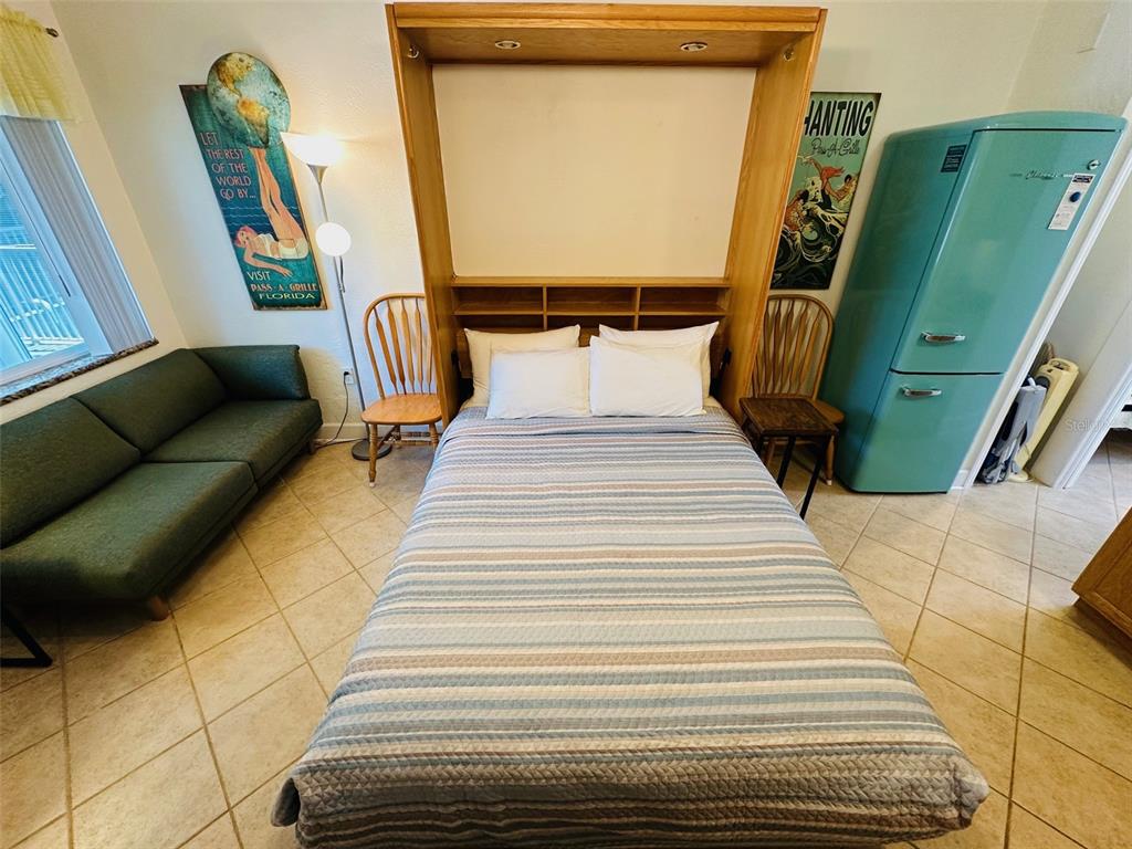 709 Gulf Way, Unit 19 St. Pete Beach, FL 33706 - Photo 17 of 39 a bedroom with a bed and a mirror