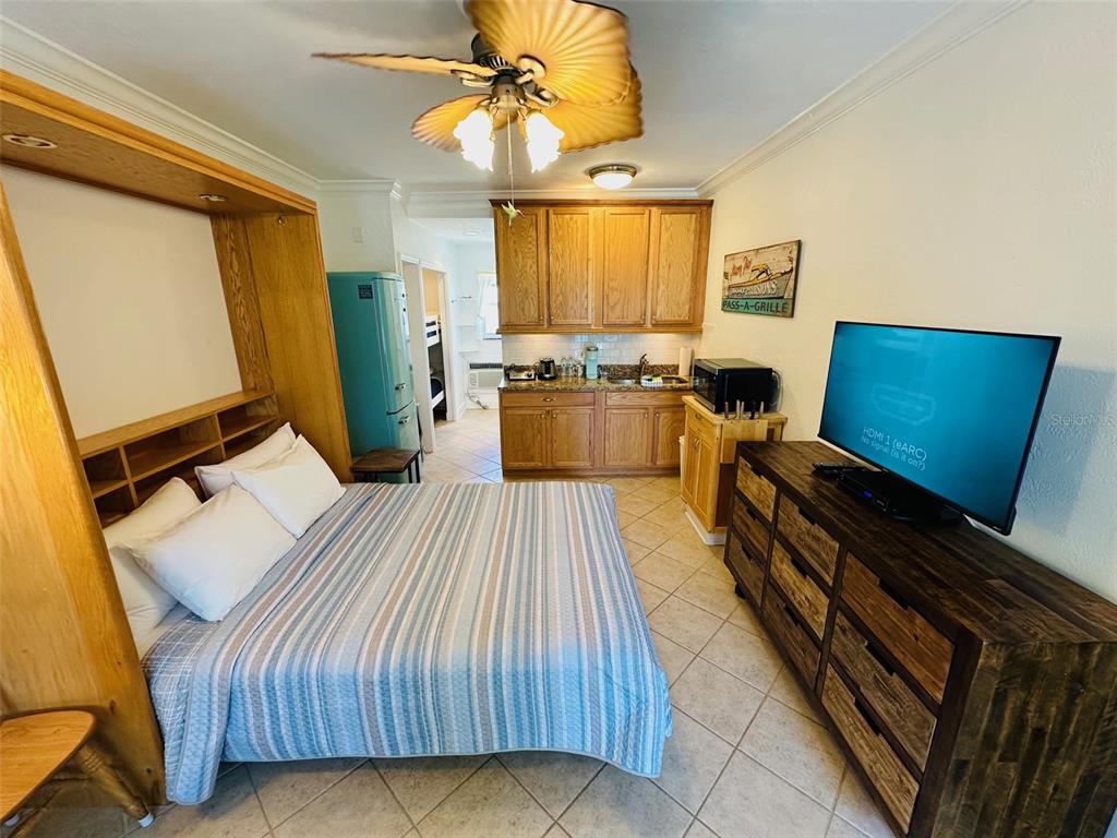 709 Gulf Way, Unit 19 St. Pete Beach, FL 33706 - Photo 18 of 39 a bed room with a bed and furniture