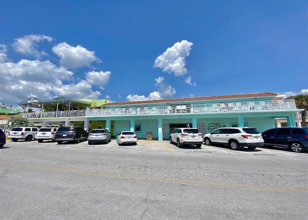 709 Gulf Way, Unit 19 St. Pete Beach, FL 33706 - Photo 2 of 39 a view of a cars park in front of a building