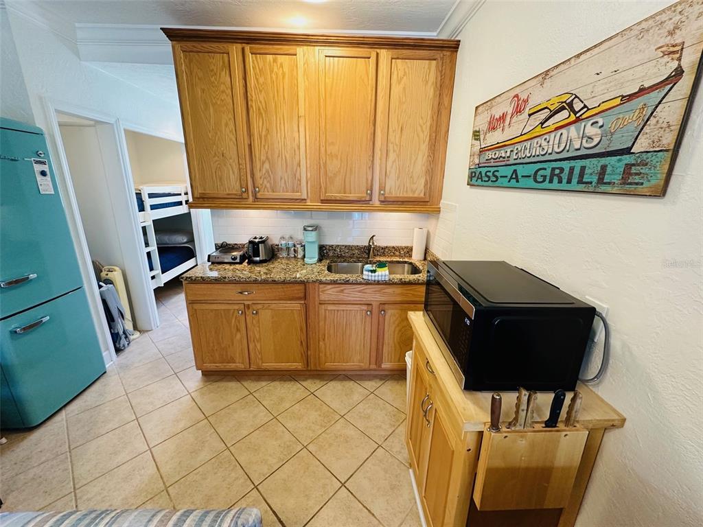 709 Gulf Way, Unit 19 St. Pete Beach, FL 33706 - Photo 21 of 39 a utility room with a sink a washer and dryer