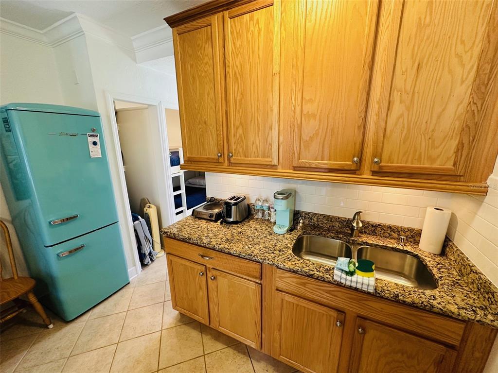 709 Gulf Way, Unit 19 St. Pete Beach, FL 33706 - Photo 23 of 39 a kitchen with sink a refrigerator and washer