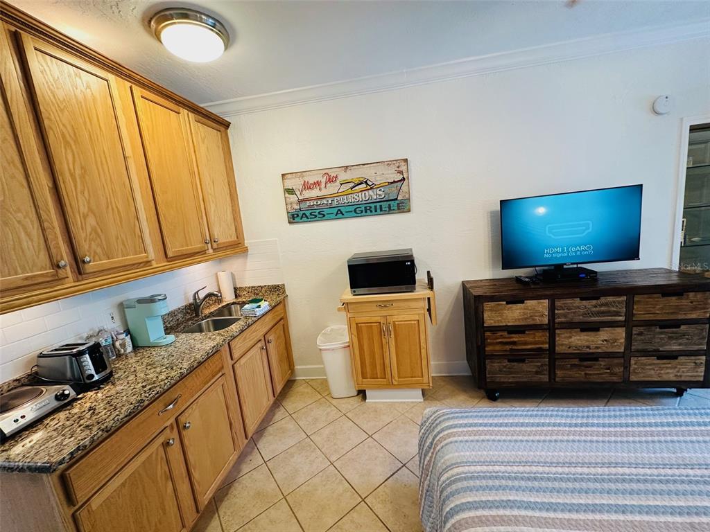 709 Gulf Way, Unit 19 St. Pete Beach, FL 33706 - Photo 28 of 39 a view of a livingroom with furniture and a flat screen tv