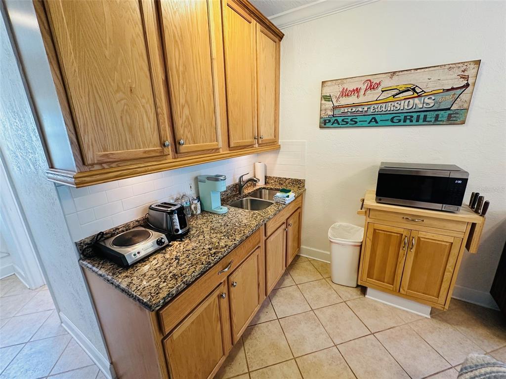 709 Gulf Way, Unit 19 St. Pete Beach, FL 33706 - Photo 29 of 39 a room with furniture and flat screen tv