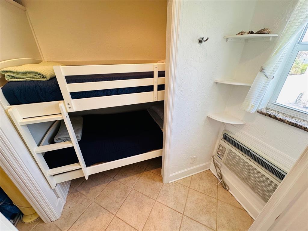 709 Gulf Way, Unit 19 St. Pete Beach, FL 33706 - Photo 30 of 39 a utility room with washing machine and racks