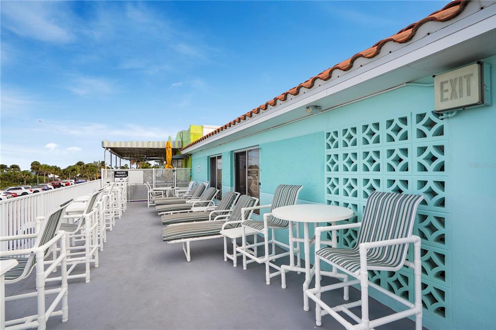709 Gulf Way, Unit 19 St. Pete Beach, FL 33706 - Photo 3 of 39 a view of a patio with a table and chairs