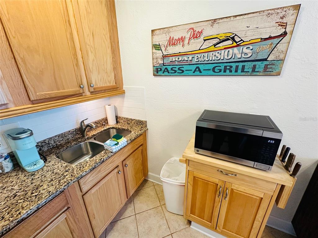 709 Gulf Way, Unit 19 St. Pete Beach, FL 33706 - Photo 31 of 39 a kitchen with a stove and a microwave