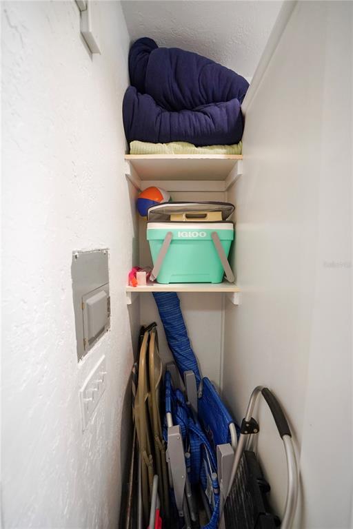 709 Gulf Way, Unit 19 St. Pete Beach, FL 33706 - Photo 36 of 39 a view of walk in closet with clothes and shoes