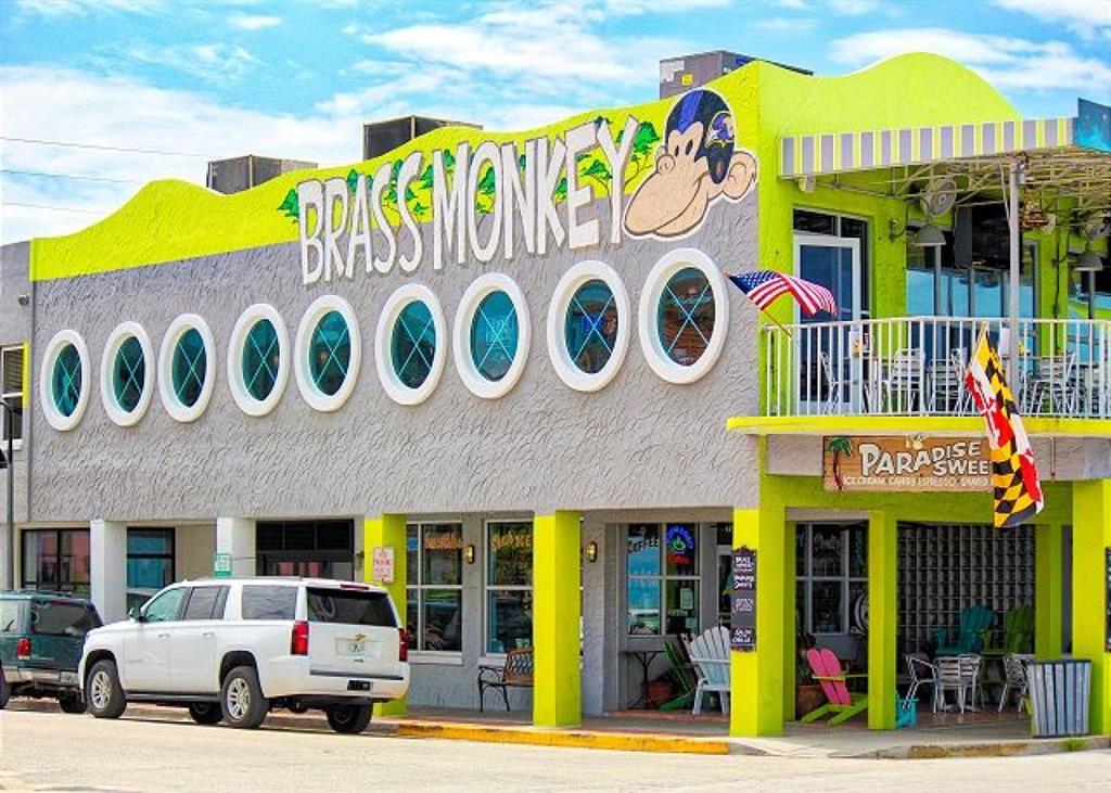 709 Gulf Way, Unit 19 St. Pete Beach, FL 33706 - Photo 39 of 39 a front view of a building with retail shop and a sign board