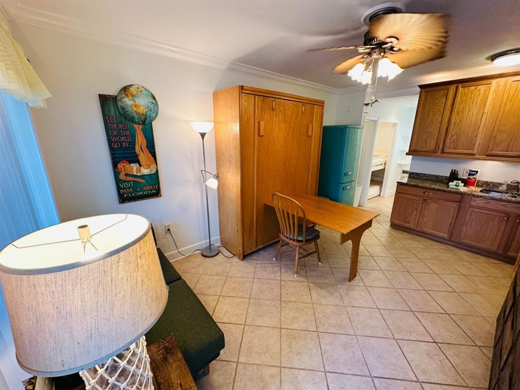 709 Gulf Way, Unit 19 St. Pete Beach, FL 33706 - Photo 9 of 39 a living room with a couch piano table and a large mirror