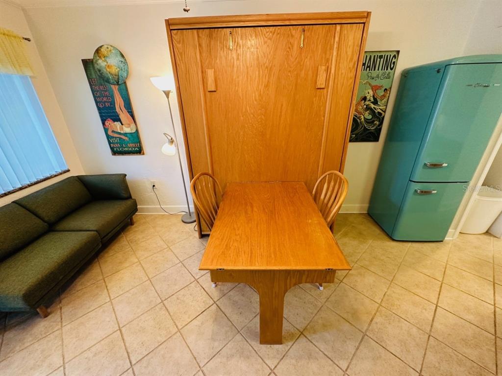 709 Gulf Way, Unit 19 St. Pete Beach, FL 33706 - Photo 10 of 39 a bedroom with a bed and furniture