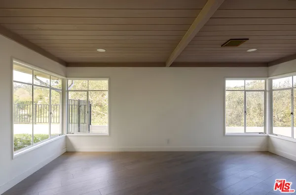 a view of a livingroom with wooden floor and window