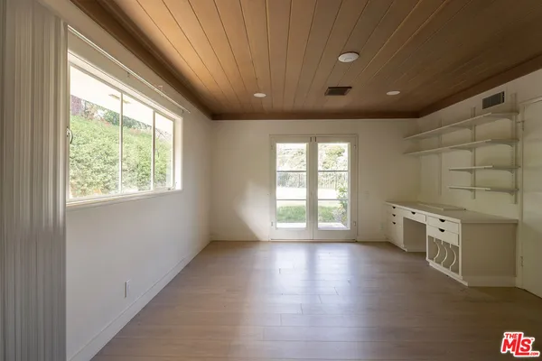 a living room with fireplace furniture and a large window