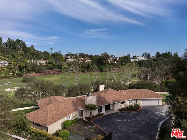 an aerial view of a house with garden space and lake view