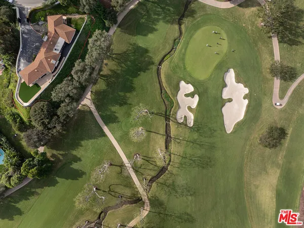 an aerial view of a houses with a yard