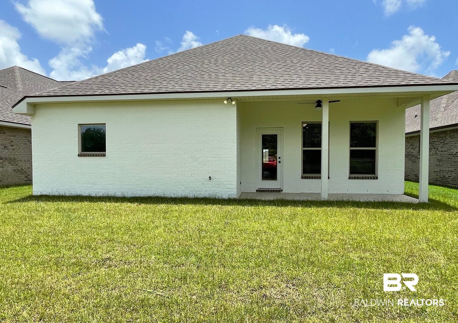 1626 Fenton Circle Foley, AL 36535 - Photo 14 of 16 Rear view of property with ceiling fan and a lawn
