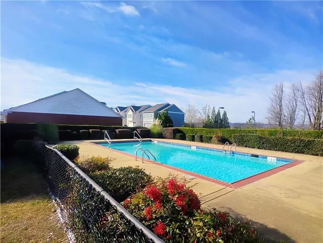 a view of a swimming pool with an outdoor seating