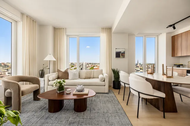 a living room with furniture and a large mirror